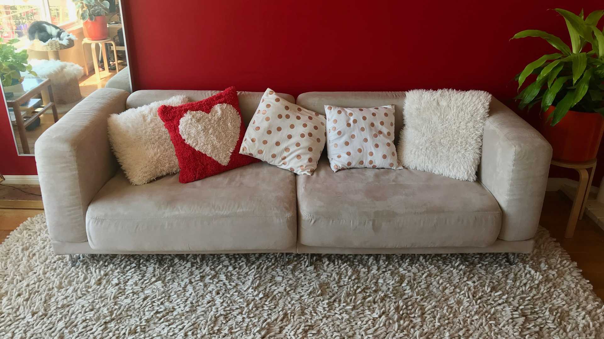 banner image: a sofa in front of a red wall